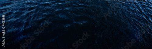 Dark gloomy surface of the water © savelov