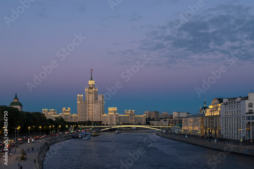 Kotelnicheskaya skyscraper just after sunset. Bolshoi Ust'insky bridge over Moscow river. Russia..