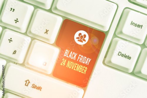 Text sign showing Black Friday 24 November. Business photo text Special sales Thanksgiving discounts Clearance White pc keyboard with empty note paper above white background key copy space photo