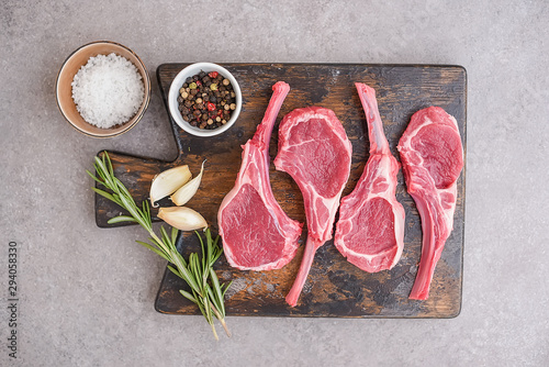 Raw lamb chops on stone background