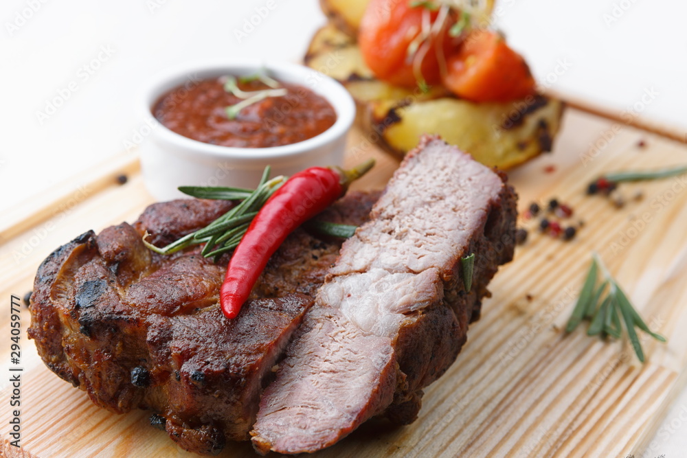 Meat steak with sauce on a wooden board