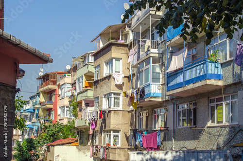Fototapeta Naklejka Na Ścianę i Meble -  Narrow streets with low colorful houses. Mediterranean style. Middle Eastern flavor. Historical concept. Hipster background. Facades of buildings decorated in boho style. Turkey, Istanbul