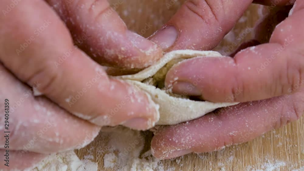 Woman Sculpts Dumplings at Home Kitchen. Hand woman cook. Close-up. Woman Sculpts Dumplings at Home Kitchen. Hand woman cook. Close-up.