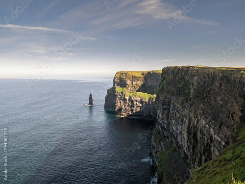 View on Cliff of Moher, Popular tourists destination in county Clare, Ireland. Warm sunny day, Blue sky and water.