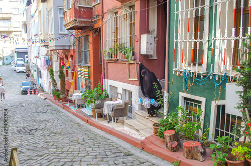 Narrow streets with low colorful houses. Mediterranean style. Middle Eastern flavor. Historical concept. Hipster background. Facades of buildings decorated in boho style. Turkey, Istanbul