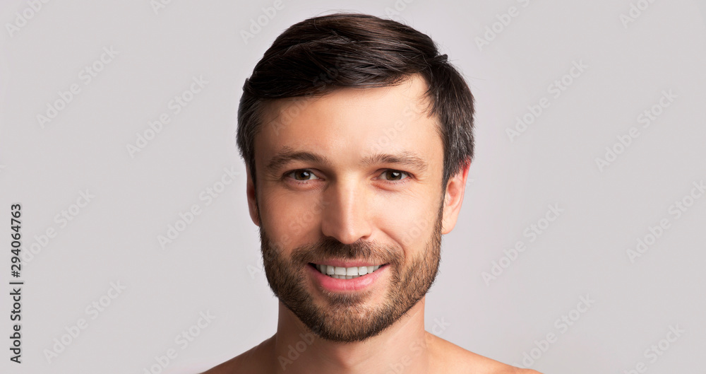 Fototapeta premium Smiling Middle-Aged Man Looking At Camera Over White Background, Panorama