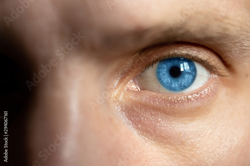 bright male eyes with blue iris, close up