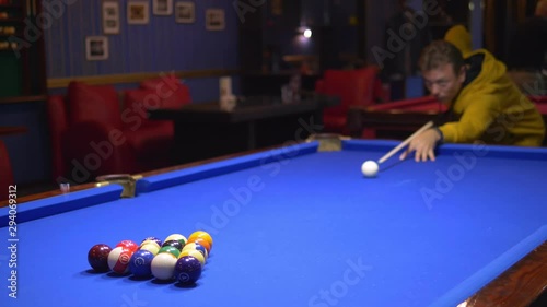 fashionable guy puts on a pool table A full set of billiards in a triangular frame on a green frieze. copy space photo