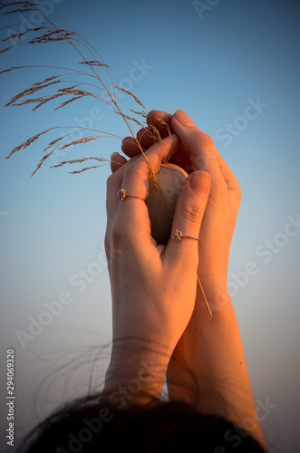 woman's hand in front of sky background