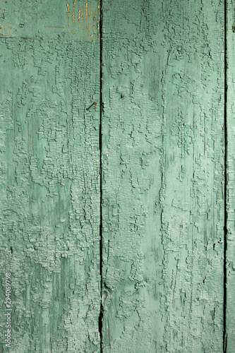 Light desaturated green, mint old stressed, weathered, cracked rusic painted exterior timber planks plain background texture