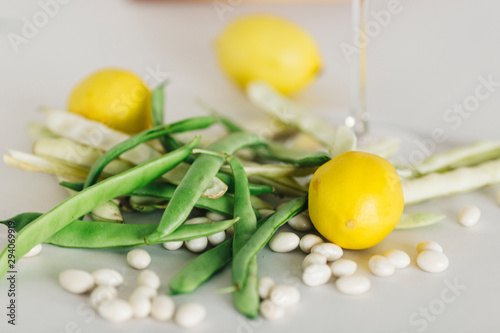 Green beans and lemon  in glass with white background