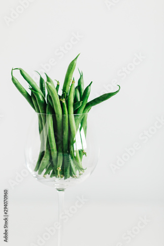 green beans in glass with white background