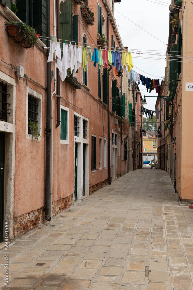 Narrow street with colorful houses in the city of Venice