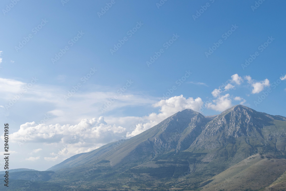 View of mountains and blue sky with clouds