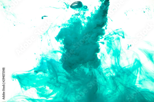 colorful blue ink isolated on white background, cloud of paint swirling in water, liquid dynamic abstract background