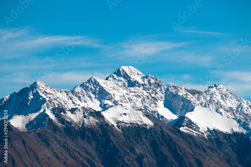 alps in winter, cold winter snow capped mountains, beautiful nature landscape background, mountain and blue sky