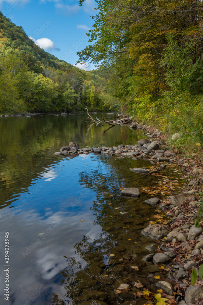 River in Cornwall, New England in early fall showing reflections of deep blue fall sky River in Cornwall, New England in early fall showing reflections of deep blue fall sky