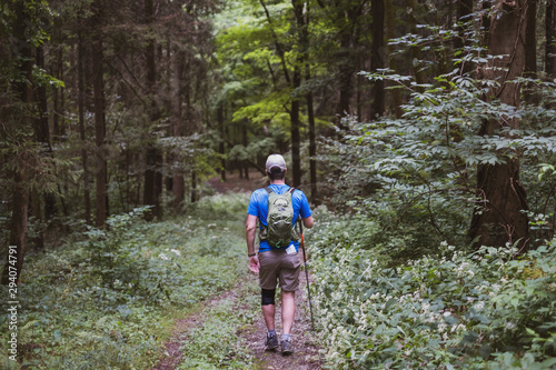 Fotografie, Obraz Man hiking or walking in the woods