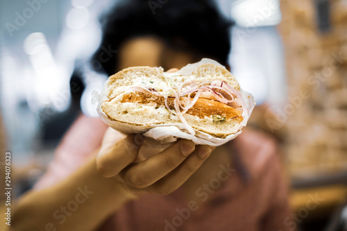 Person holding half a lox bagel photo