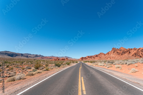Driving on Small Park Road with Large Mountain Formations All Around
