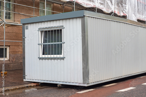 Temporary construction building. hange house outside. A small house for builders. The building is being renovated. Shed with window and ventilation. Sale of change house.