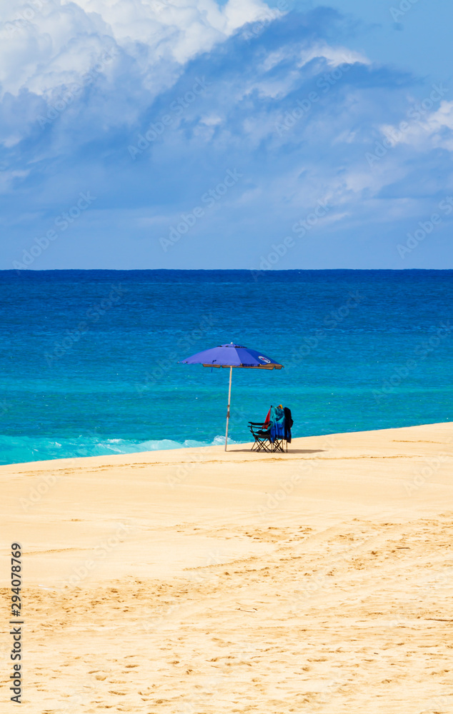 Beach umbrella and chairs on the north shore of Oahu Hawaii