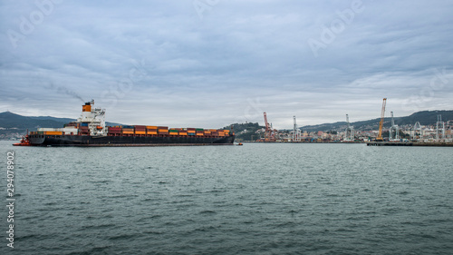 merchant ship docking at the port to unload