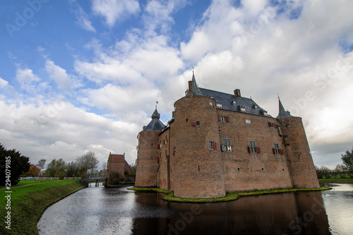 Fotografering Medieval European Brick Castle with Large Moat and Later Renovations