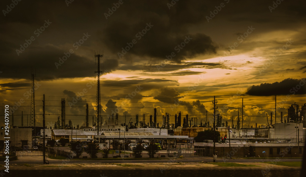 Factory smokestacks and clouds at sunset