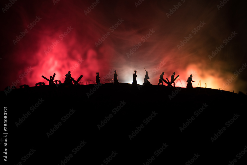 War Concept. Military silhouettes fighting scene on war fog sky background, World War German Tanks Silhouettes Below Cloudy Skyline At night. Attack scene. Armored vehicles and infantry.