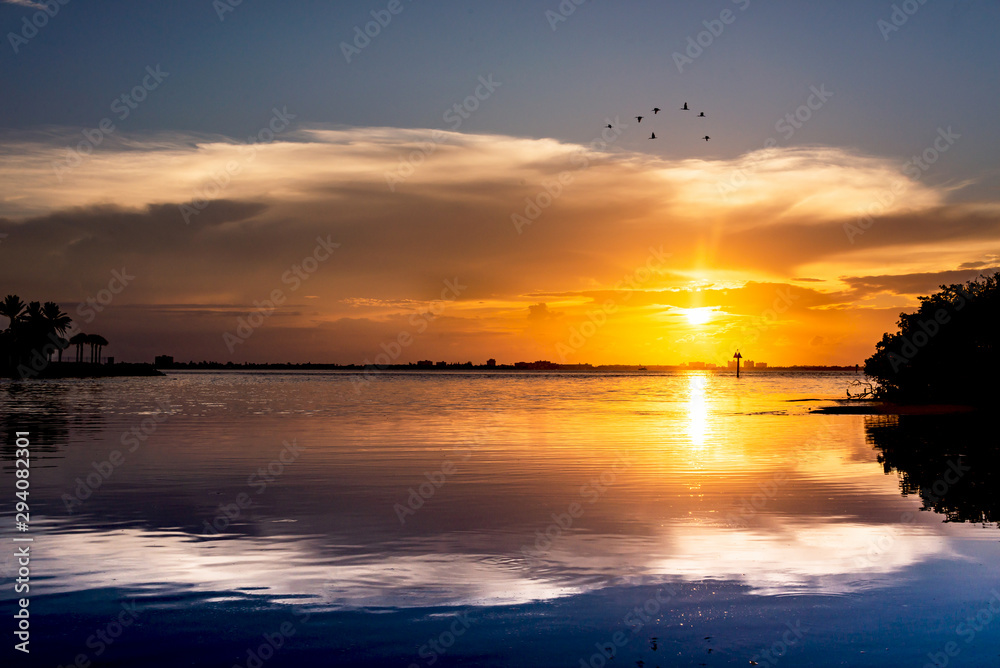 Sunset sky at the beach, flock of birds, beautiful landscape Sunset sky at the beach, flock of birds, beautiful landscape