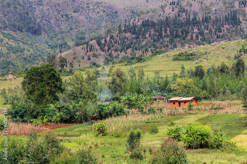 Typical subsistence farmer household in the Gitega Province of Burundi with terraces and eroding hilltops in the background