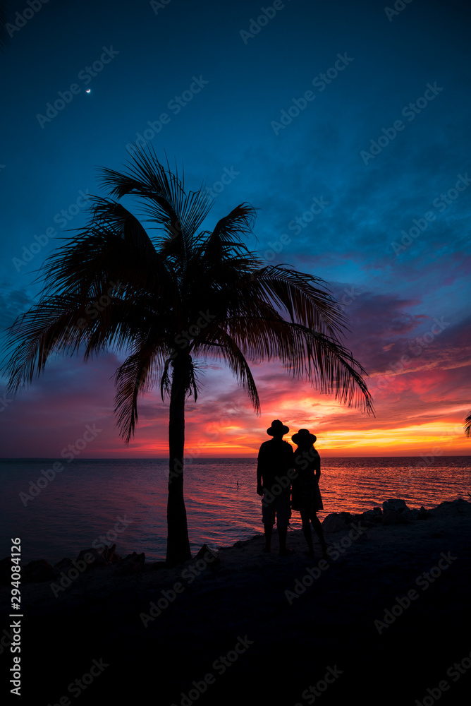 Couple contemplating the sunset at Holbox Island in the Caribbean Ocean of Mexico