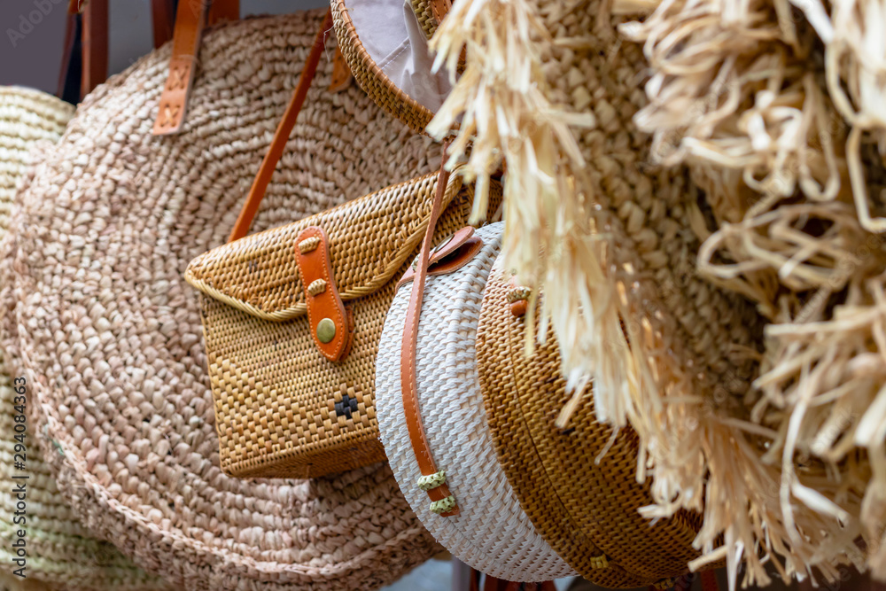 Balinese traditional handmade rattan woven round shoulder bags with leather handles at a souvenir street shop. Bali, Indonesia