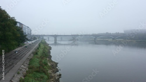 Wallpaper Mural Drone flies to a bridge in the fog in the city of Warsaw. Poland. Aerial view of the river and bridge on a foggy day. Drone flight on a bridge with cars and public transport in the fog. 4K Drone Shot. Torontodigital.ca
