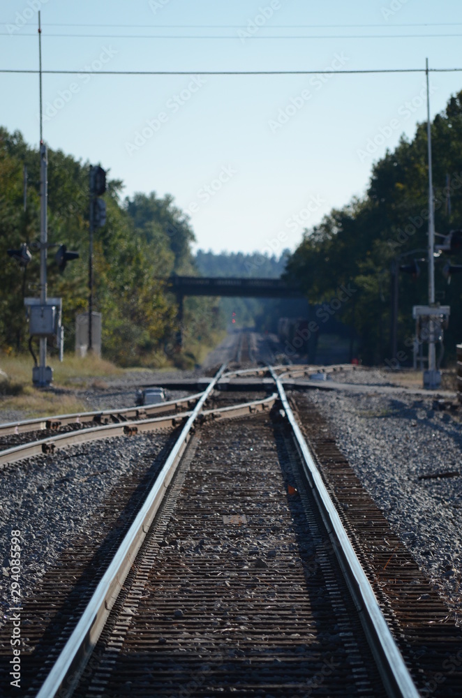 Looking down railroad tracks with a switch rail joining
