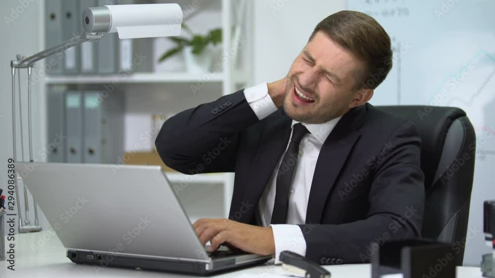 Office head working on laptop, suffering strong pain in neck, inflammation Office head working on laptop, suffering strong pain in neck, inflammation