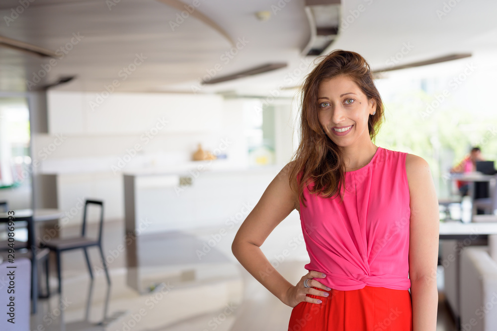 Happy beautiful Hispanic woman smiling at home indoors Happy beautiful Hispanic woman smiling at home indoors