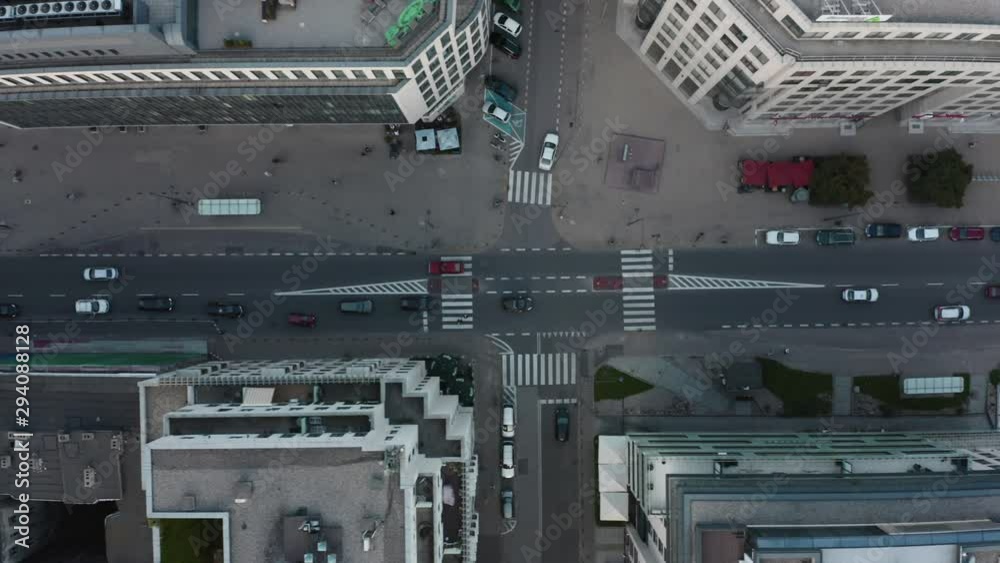 Drone shot on the street with intersections and cars. Car traffic on the road and people cross the street during the day in the center of Warsaw drone aerial view from above. 4K Shot. Drone shot on the street with intersections and cars. Car traffic on the road and people cross the street during the day in the center of Warsaw drone aerial view from above. 4K Shot.