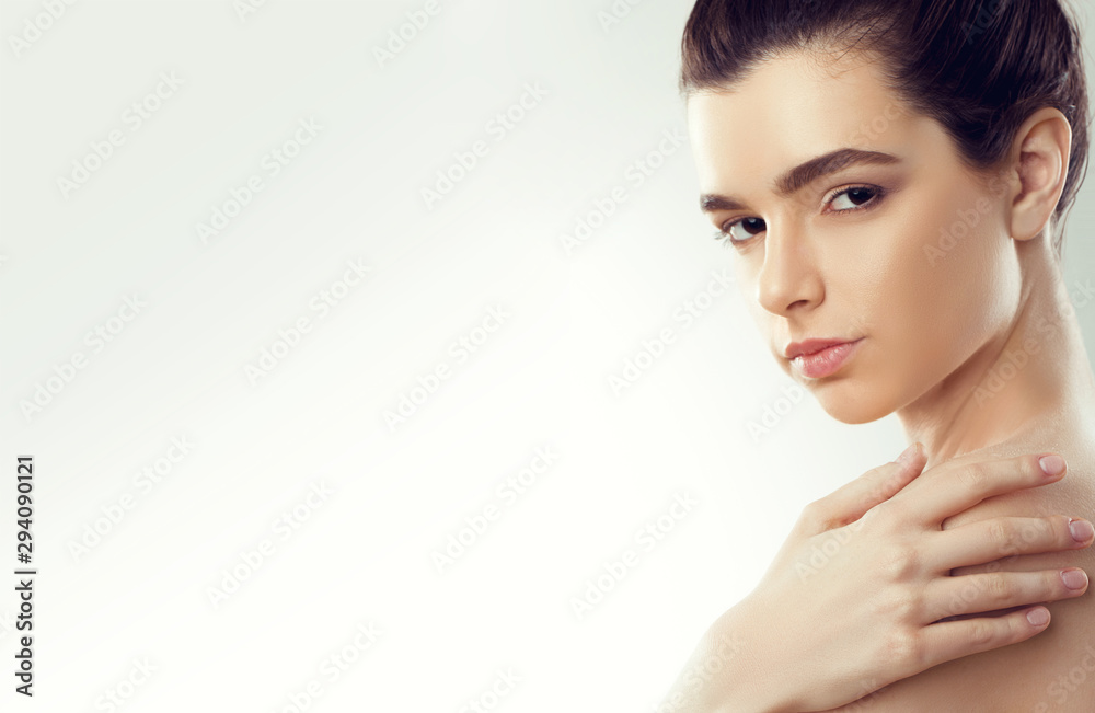 Naklejka premium Beauty Face. Beautiful Woman With Natural Makeup touch own face. Girl With Clean Fresh Skin. Closeup. Cosmetology. Skincare. High Resolution
