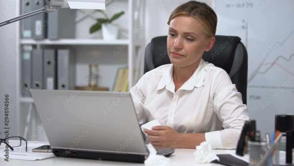 Office woman with napkin in her hands sneezing, lacrimation, allergic rhinitis Office woman with napkin in her hands sneezing, lacrimation, allergic rhinitis