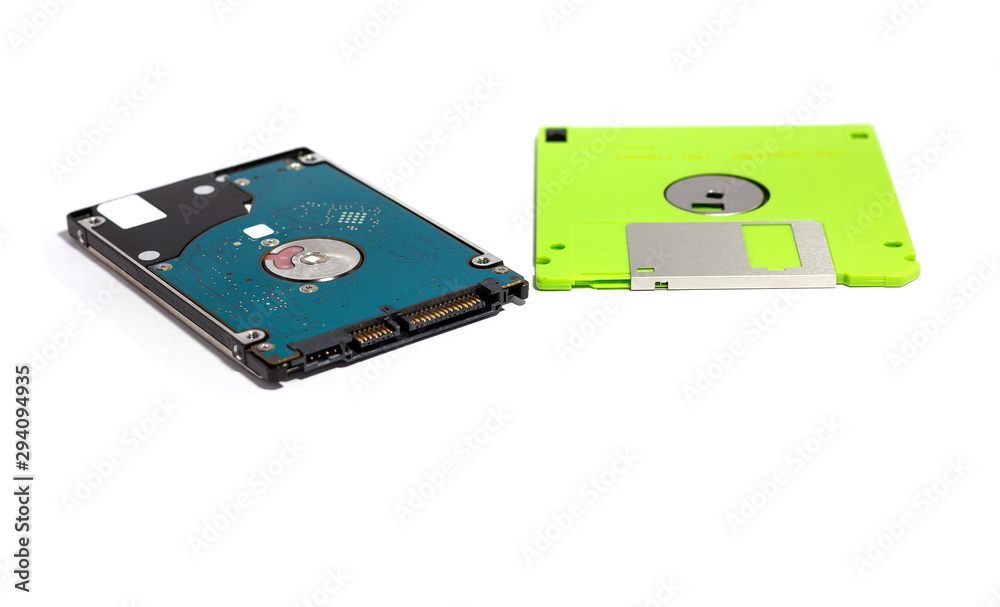 The difference between storage devices. Old technology of floppy disk and new technology of hard disk. isolated on white The difference between storage devices. Old technology of floppy disk and new technology of hard disk. isolated on white