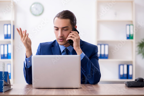 Young male accountant working in the office