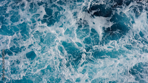 Texture of marine splashes. crashing ocean wave foam structure. Dark blue clear water. Ocean depth.