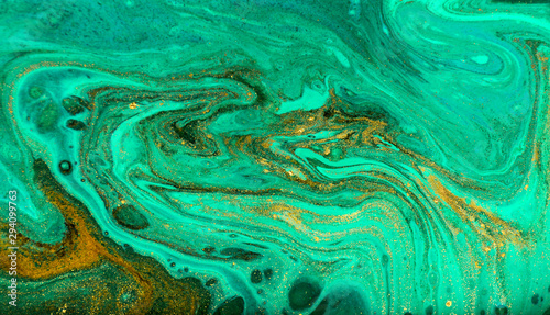Green and gold ripple of agate background. Golden powder marble texture.