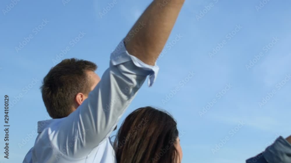 Happy romantic couple dancing on date, holding hands on sky background slow-mo Happy romantic couple dancing on date, holding hands on sky background slow-mo