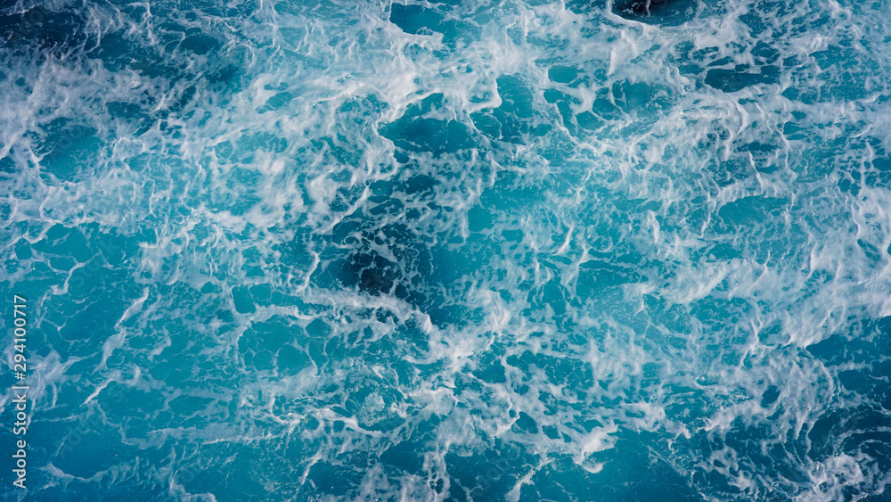 Texture of marine splashes. crashing ocean wave foam structure. Dark blue clear water. Ocean depth.