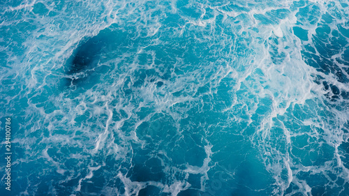 Texture of marine splashes. crashing ocean wave foam structure. Dark blue clear water. Ocean depth.