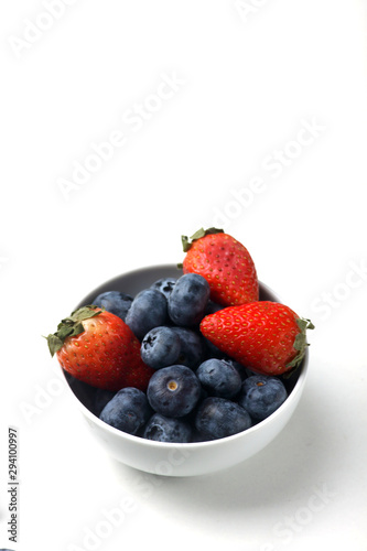 a bowl of strawberry and blueberry isolated on white background