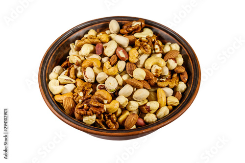 Bowl with mixed nuts isolated on white background. Walnuts, pistachio, almond, peanut, cashew, hazelnut in ceramic bowl